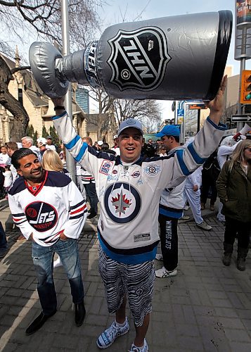 PHIL HOSSACK / WINNIPEG FREE PRESS - Jets fan Ryan Anderson raises an inflatable Stanley Cup over his head waiting to enter the Street Party Wednesday. See story.   - April 11, 2018
