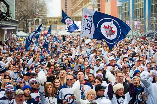 MIKAELA MACKENZIE / WINNIPEG FREE PRESS
Fans fly their flags at the Jets whiteout party on Donald Street in Winnipeg on Wednesday, April 11, 2018. 
Mikaela MacKenzie / Winnipeg Free Press 2018.