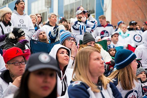 MIKAELA MACKENZIE / WINNIPEG FREE PRESS
Fans watch the first period at the Jets whiteout party on Donald Street in Winnipeg on Wednesday, April 11, 2018. 
Mikaela MacKenzie / Winnipeg Free Press 2018.