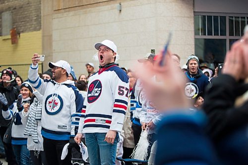 MIKAELA MACKENZIE / WINNIPEG FREE PRESS
Fans cheer at the Jets whiteout party on Donald Street in Winnipeg on Wednesday, April 11, 2018. 
Mikaela MacKenzie / Winnipeg Free Press 2018.