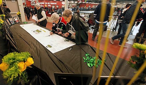 PHIL HOSSACK / WINNIPEG FREE PRESS -  Virden Oil Capitals fans sign a tribute card to the Humbolt Broncos at the Virden Tundra Oil Gas Place  Thursday. Melissa Martin story.- April 12, 2018