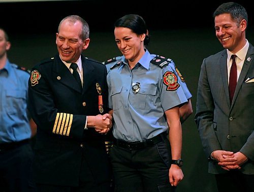 BORIS MINKEVICH / WINNIPEG FREE PRESS
FIRE GRAD 1801 - From left, WFPS Chief John Lane congratulates grad #2500 Katy Butland while Mayor Brian Bowman watches at The Metropolitan Entertainment Centre this afternoon. 16 new recruits graduated today. April 13, 2018