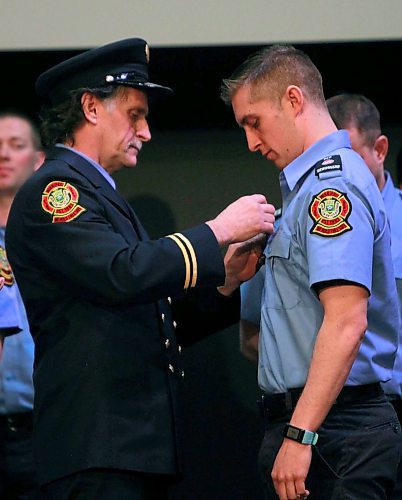 BORIS MINKEVICH / WINNIPEG FREE PRESS
FIRE GRAD 1801 - WFPS retired firefighter Gary Oakley got the honour of presenting his son Ted with his badge #2501 at The Metropolitan Entertainment Centre this afternoon. 16 new recruits graduated today. April 13, 2018