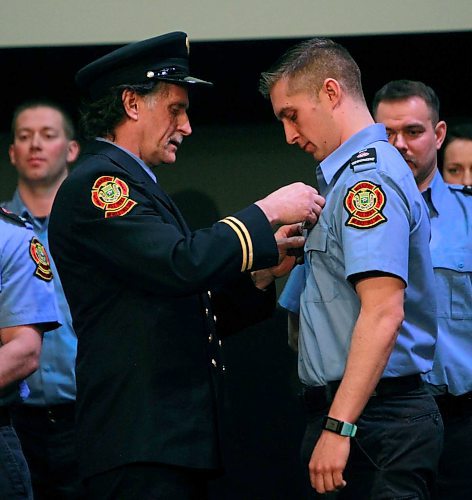 BORIS MINKEVICH / WINNIPEG FREE PRESS
FIRE GRAD 1801 - WFPS retired firefighter Gary Oakley got the honour of presenting his son Ted with his badge #2501 at The Metropolitan Entertainment Centre this afternoon. 16 new recruits graduated today. April 13, 2018