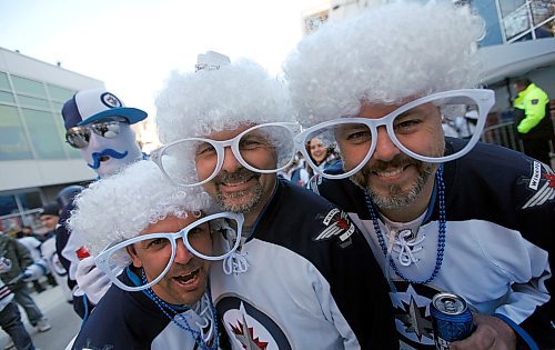 PHIL HOSSACK / WINNIPEG FREE PRESS -left to right, Brad Gauthier, Jason Pilgrim and Ryan Boyle take a close look around on Donald Street Friday evening. Buddy Bernie Laramie, didn't get the memo and wore the wrong glasses peers over their shoulders. Stand-Up - April 13, 2018