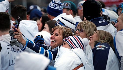 PHIL HOSSACK / WINNIPEG FREE PRESS -Jets revellers squeeze in a selfie in the standing room only crowd on Donald Street Friday. Stand-Up - April 13, 2018