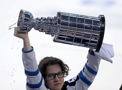 TREVOR HAGAN / WINNIPEG FREE PRESS
Fans drink out of a miniature Stanley Cup being passed around the rink as the Winnipeg Jets' play the Minnesota Wild during game 2 NHL play-off hockey action, Friday, April 13, 2018.