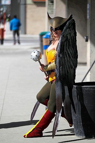 PHIL HOSSACK / WINNIPEG FREE PRESS - Comic-con Stand Up - The Justice League's "Hawk Woman" AKA Kristin Dubois, took a break from the gathering being held inside the RBC Convention Centre Saturday afternoon to pose outside for some photos with a friend and her tablet. Manitoba Comic Con, a bite-sized version of Central Canada Comic Con, is on at the convention centre from 10 a.m. to 6 p.m. Saturday and Sunday.Richard Brake, who plays the Night King (under makeup and prosthetics) on Game of Thrones, is doing autographs and pictures from 10:30 to noon both days.  - April 14, 2018