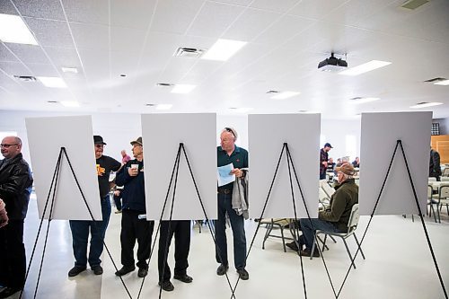 MIKAELA MACKENZIE / WINNIPEG FREE PRESS
People take a look at the information boards set up at the rec centre before Premier Brian Pallister speaks at a town hall on the proposed Lake Manitoba outlet in St. Laurent, Manitoba on Monday, April 16, 2018. 
Mikaela MacKenzie / Winnipeg Free Press 2018.