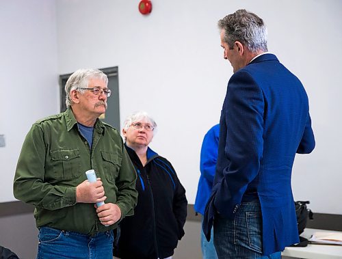 MIKAELA MACKENZIE / WINNIPEG FREE PRESS
Premier Brian Pallister says chats with farmers Ross and Helen Jermey at a town hall on the proposed Lake Manitoba outlet in St. Laurent, Manitoba on Monday, April 16, 2018. 
Mikaela MacKenzie / Winnipeg Free Press 2018.