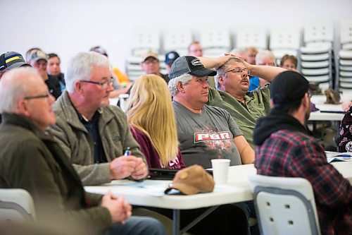 MIKAELA MACKENZIE / WINNIPEG FREE PRESS
Dan (right) and Devon Meisner listen as Premier Brian Pallister speaks at a town hall on the proposed Lake Manitoba outlet in St. Laurent, Manitoba on Monday, April 16, 2018. 
Mikaela MacKenzie / Winnipeg Free Press 2018.