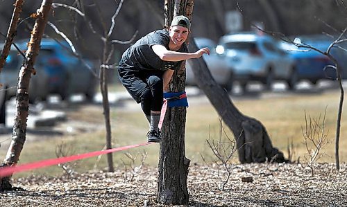 PHIL HOSSACK / WINNIPEG FREE PRESS - STAND-UP- Josh Hutton took advantage of a day off work (and double digit temperatures for the first time since October last year) to hone his slack line walk in Assinaboine Park Tuesday. - April 17, 2018