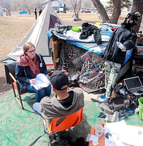 BORIS MINKEVICH / WINNIPEG FREE PRESS
A Street Census of homeless Winnipeggers was done today. This photo was taken in the park at the corner of Higgins and Main. Here volunteer Heather Campbell-Enns, left, interviews a homeless person at a makeshift camp in the back corner of the park near the tracks. April 18, 2018