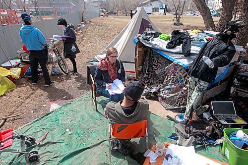 BORIS MINKEVICH / WINNIPEG FREE PRESS
A Street Census of homeless Winnipeggers was done today. This photo was taken in the park at the corner of Higgins and Main. Here volunteer Heather Campbell-Enns, right sitting down, interviews a homeless person while Lisa Manning, behind left, interviews another homeless person. This was in a makeshift shanty camp in the back corner of the park near the train tracks. April 18, 2018
