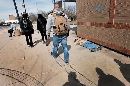 PHIL HOSSACK / WINNIPEG FREE PRESS -Volunteers walk past homelessness along Main Street as they head out to survey homeless residents of the city for the Street Census. See Ryan's story. - April 18, 2018