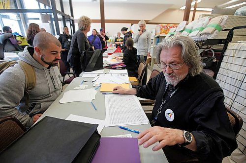 PHIL HOSSACK / WINNIPEG FREE PRESS - Formerly homeless himself, Al Wiebe (right) signs in volunteers at the Main Street Project before they conduct the Street Survey. See Ryan's story. - April 18, 2018