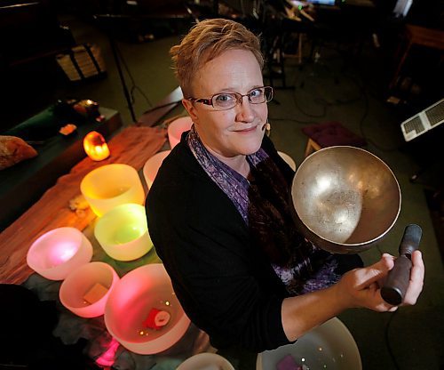 PHIL HOSSACK / WINNIPEG FREE PRESS - Holding a brass "Singing Bowl", L'aura Carroll poses with her Crystal Bowls Wednesday at the Home Street Mennonite Church where she and her husband Danny were to perform. See Brenda Suderman's story.- April 18, 2018