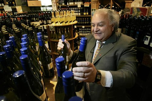 John Woods / Winnipeg Free Press / December 19/08 - 081219  - Mo Razik, owner of Fenton;'s Wine Merchants and Chairman of the Independent Specialty Wine Stores of Manitoba stocks shelves in his Forks Market store Friday, December 19, 2008.