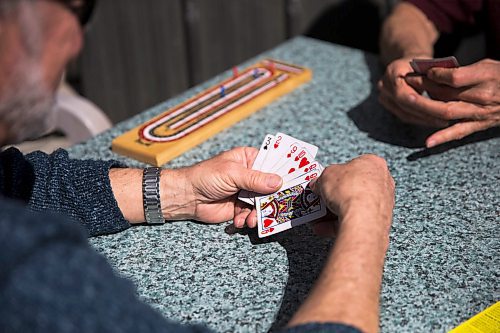 MIKAELA MACKENZIE / WINNIPEG FREE PRESS
Rob Miller (left) plays crib on the patio with his friend, James McBride, on Bar Italia's patio in the warm spring weather on Corydon in Winnipeg on Thursday, April 19, 2018. A new patio smoking ban on took effect on April first.
Mikaela MacKenzie / Winnipeg Free Press 2018.