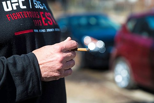 MIKAELA MACKENZIE / WINNIPEG FREE PRESS
Garry Walker smokes across the street from Bar Italia's patio in the warm spring weather on Corydon in Winnipeg on Thursday, April 19, 2018. A new patio smoking ban on took effect on April first.
Mikaela MacKenzie / Winnipeg Free Press 2018.