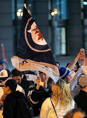 PHIL HOSSACK / WINNIPEG FREE PRESS -  Jets fans celebrate at Portage and Main Friday evening after the the Winnipeg Jets win playoff series against the Minnesota Wild. - April 20, 2018