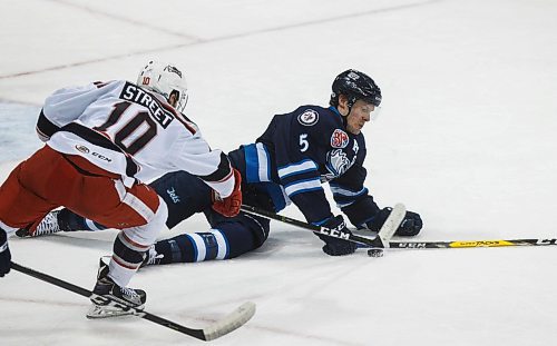 MIKE DEAL / WINNIPEG FREE PRESS
Manitoba Moose Cameron Schilling (5) goes down while checking the puck off of Grand Rapids Griffins Ben Street (10) during the first period of game 1 of the first round of the AHL playoffs at Bell MTS Place Saturday afternoon.
180421 - Saturday, April 21, 2018.