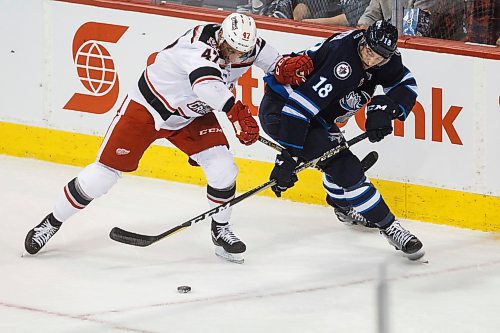 MIKE DEAL / WINNIPEG FREE PRESS
Manitoba Moose Brody Sutter (18) stick handles the puck around the net while being checked by Grand Rapids Griffins Corey Elkins (47) during game 1 of the first round of the AHL playoffs at Bell MTS Place Saturday afternoon.
180421 - Saturday, April 21, 2018.