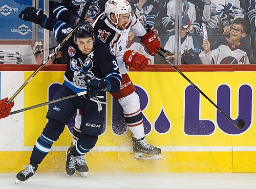 MIKE DEAL / WINNIPEG FREE PRESS
Manitoba Moose JC Lipon (34) takes Grand Rapids Griffins Dylan McIlrath (52) out of the play during game 1 of the first round of the AHL playoffs at Bell MTS Place Saturday afternoon.
180421 - Saturday, April 21, 2018.