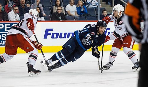 MIKE DEAL / WINNIPEG FREE PRESS
Manitoba Moose Chase De Leo (9) is tripped up by Grand Rapids Griffins Dan Renouf (20) during the second period of game 1 of the first round in the AHL playoffs at Bell MTS Place Saturday afternoon.
180421 - Saturday, April 21, 2018.