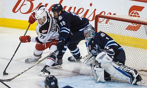 MIKE DEAL / WINNIPEG FREE PRESS
Manitoba Moose Brody Sutter (18) tries to keep Grand Rapids Griffins Evgeny Svechnikov (77) from getting a shot on net during the third period of game 1 of the first round in the AHL playoffs at Bell MTS Place Saturday afternoon.
180421 - Saturday, April 21, 2018.