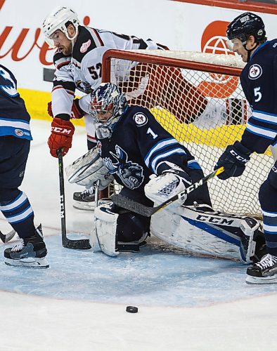 MIKE DEAL / WINNIPEG FREE PRESS
Manitoba Moose goaltender Eric Comrie (1) keeps the puck out of the net from a wraparound from Grand Rapids Griffins Dylan McIlrath (52) during the third period of game 1 of the first round in the AHL playoffs at Bell MTS Place Saturday afternoon.
180421 - Saturday, April 21, 2018.
