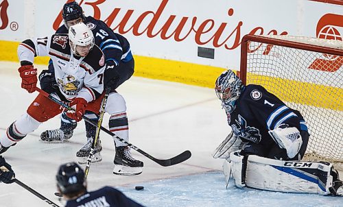 MIKE DEAL / WINNIPEG FREE PRESS
Manitoba Moose Brody Sutter (18) tries to keep Grand Rapids Griffins Evgeny Svechnikov (77) from getting a shot on net during the third period of game 1 of the first round in the AHL playoffs at Bell MTS Place Saturday afternoon.
180421 - Saturday, April 21, 2018.