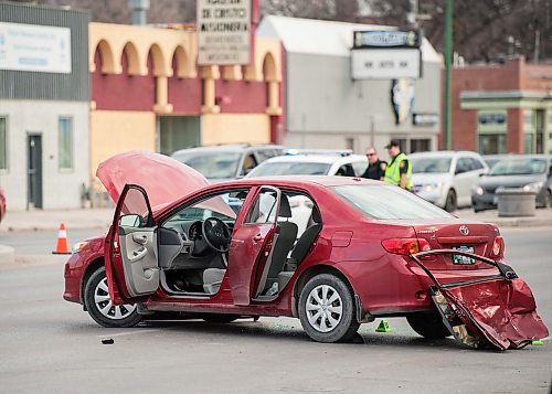MIKE SUDOMA PHOTO
The aftermath of a traffic collision Saturday evening resulting in 3 people (2 police officers, and 1 driver of the other car) taken to hospital and police cruiser crashing into a local convenience store, Bargains Galore, on the intersection of Polson and Main St., Winnipeg MB. April 21, 2018.