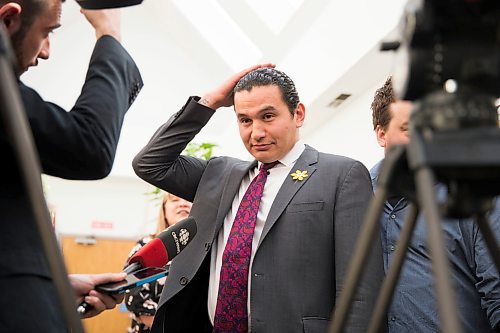 MIKAELA MACKENZIE / WINNIPEG FREE PRESS
NDP Leader Wab Kinew pats his hair after announcing legislation that would amend the Vital Statistics Act to allow Manitobans to be issued gender neutral ID at the Rainbow Resource Centre in Winnipeg on Wednesday, April 25, 2018. 
Mikaela MacKenzie / Winnipeg Free Press 2018.
