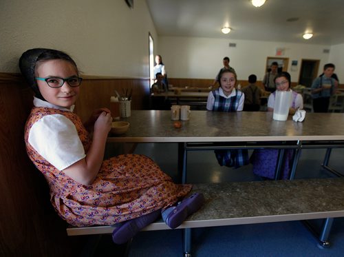 PHIL HOSSACK/Winnipeg Free Press - Hannah, an elementary student at the James Valley Hutterite Colony settles into her lunch in the children's dining room Tuesday. Children from the age of 5 -15 eat separately from their parents who dine in a separate room at the community's main kitchen hall.  James Valley Hutterite Colony home.  One of the original Hutterite settlements in Manitoba the James Valley community celebrates it's 100th Anniversary this year.  -  April 24, 2018