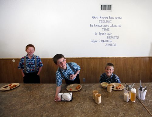PHIL HOSSACK/Winnipeg Free Press - Three young  elementary students at the James Valley Hutterite Colony settles into their lunch in the children's dining room Tuesday. Children from the age of 5 -15 eat separately from their parents who dine in a separate room at the community's main kitchen hall.  James Valley Hutterite Colony home.  One of the original Hutterite settlements in Manitoba the James Valley community celebrates it's 100th Anniversary this year.  -  April 24, 2018