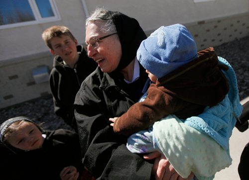 PHIL HOSSACK/Winnipeg Free Press - Lena Hofer cradles her grandson Christopher tuesday while interacting with some of the young people at their James Valley Hutterite Colony home.  One of the original Hutterite settlements in Manitoba the James Valley community celebrates it's 100th Anniversary this year.  -  April 24, 2018