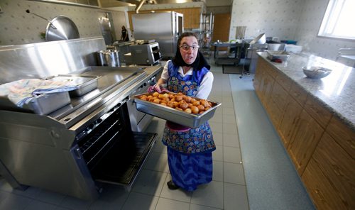 PHIL HOSSACK/Winnipeg Free Press - Melissa Hofer removes cooked dumplings from an oven the James Valley Hutterite Colony community kitchen Tuesday.   One of the original Hutterite settlements in Manitoba the James Valley community celebrates it's 100th Anniversary this year.  -  April 24, 2018