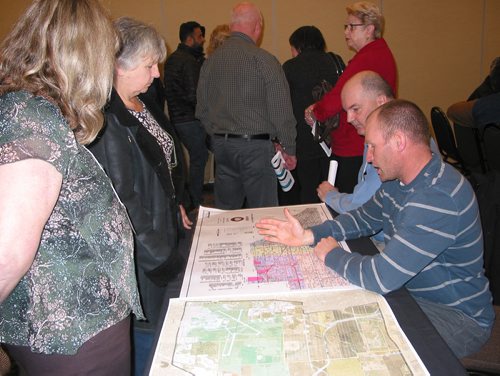 Canstar Community News April 14, 2018 - RM of Rosser councillors Scott Corbett (front) and Kevin Stewart talk to local residents about the municipality's plans for water and sewer distribution and taxation at a public meeting on April 14. (ANDREA GEARY/CANSTAR COMMUNITY NEWS)
