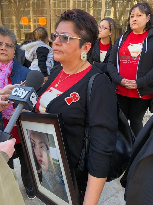 MELISSA MARTIN / WINNIPEG FREE PRESS
Surrounded by family and supporters, Dolores Daniels, the mother of Serena McKay, holds a photo of her daughter as she speaks outside court on Thursday. 
180426 - Thursday, April 26, 2018.