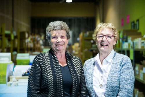 MIKAELA MACKENZIE / WINNIPEG FREE PRESS
Valerie McIntyre (left) and Roma Maconachie, longtime volunteers with International Hope, a nonprofit that provides medical supplies to impoverished countries, pose in the warehouse in Winnipeg on Thursday, April 26, 2018. 
Mikaela MacKenzie / Winnipeg Free Press 2018.