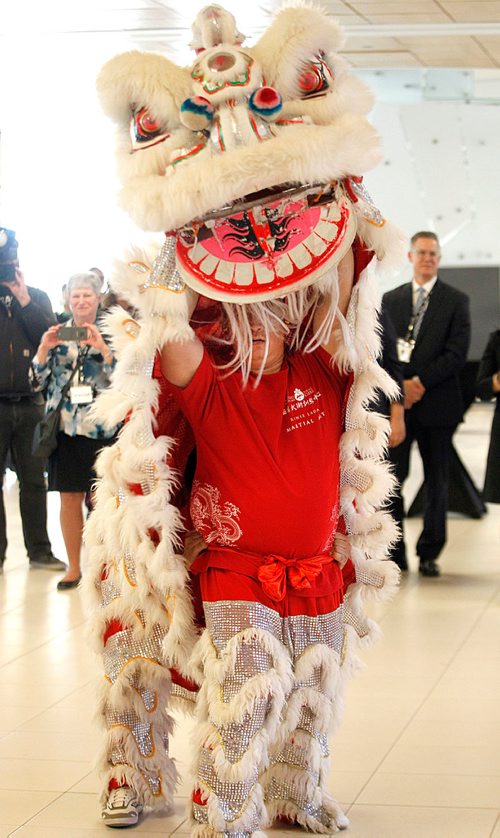 PHIL HOSSACK / WINNIPEG FREE PRESS - Ranie Laoag strains under the traditional costume of the Lion Dance at the the grand opening of Flight Club, the newest restaurant at Winnipeg Richardson International Airport. Ranie led one of a pair of the traditional dancers in Lion Costumen at the event. Dancers came from the Wushu Manitoba Training Centre to perform for the event. Winnipeg is the first North American location for Flight Club. Other locations include Kuala Lumpur, Hong Kong, and Malaysia.  STAND-UP. - April 26, 2018