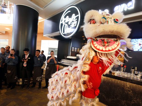 PHIL HOSSACK / WINNIPEG FREE PRESS - Ranie Laoag strains under the traditional costume of the Lion Dance at the the grand opening of Flight Club, the newest restaurant at Winnipeg Richardson International Airport. Ranie led one of a pair of the traditional dancers in Lion Costumen at the event. Dancers came from the Wushu Manitoba Training Centre to perform for the event. Winnipeg is the first North American location for Flight Club. Other locations include Kuala Lumpur, Hong Kong, and Malaysia.  STAND-UP. - April 26, 2018