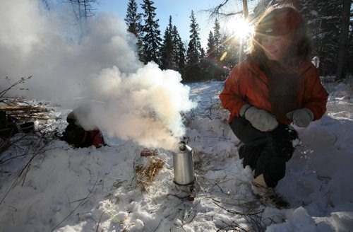 Brandon Sun Shelley Neustater boils water for tea at a makeshift lunch site in the back-country of Riding Mountain National Park on Tuesday. (Bruce Bumstead/Brandon Sun)