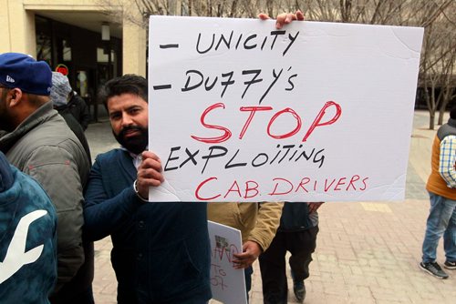 BORIS MINKEVICH / WINNIPEG FREE PRESS
Taxi drivers protest at City Hall about working conditions and abuse on the job this afternoon.  Cab driver Bhupendar Singh with a sign at the protest. JESSICA BOTELHO STORY. April 27, 2018