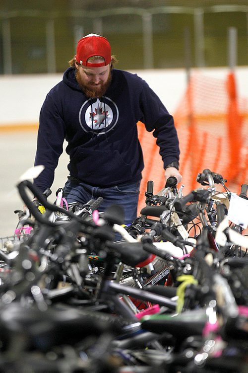 PHIL HOSSACK / WINNIPEG FREE PRESS - WOrkers unpack hundreds of bicycles from a pair of tractor trailer units at the Terry Sawchuk arena for the city's annual unclaimed bicycle auction sale.STAND-UP - April 27, 2018