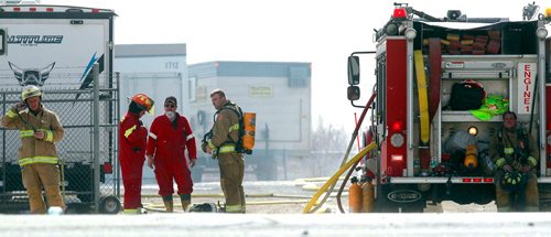 BORIS MINKEVICH / WINNIPEG FREE PRESS
A grass fire spreads to a portable office on the site of Industrial Trailer Sales & Rentals on Fermor just east of Lakeside Road. In this photo a firefighters take a break from fighting the fire. Extreme wind has made the fire hard to fight. April 29, 2018