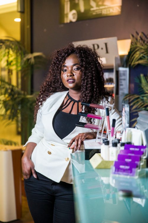 MIKAELA MACKENZIE / WINNIPEG FREE PRESS
Francine Bahati founder of Queenfidence, a new cosmetic line, poses at Ambience Hair Salon (where her products are sold) in Winnipeg on Tuesday, May 1, 2018. Francine fled the Congo at age 10 and spent years in Uganda, living in a one-room apartment with her large family, where she made her own makeup with palm oil and whatever else she could find. Her family came to Winnipeg four years ago and in December 2017 she launched Queenfidence. 
Mikaela MacKenzie / Winnipeg Free Press 2018.