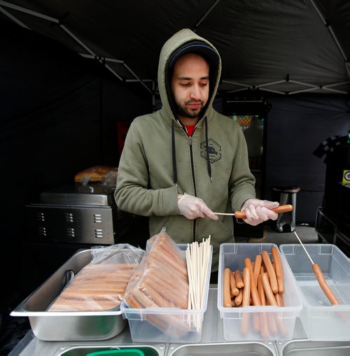 PHIL HOSSACK / WINNIPEG FREE PRESS - STREET PARTY - Jonathan Cable begins the process of prepping over 300 corn dogs he expected to se at the Jets Whiteout Party Tuesday.   Jessica's story.  - May 1, 2018