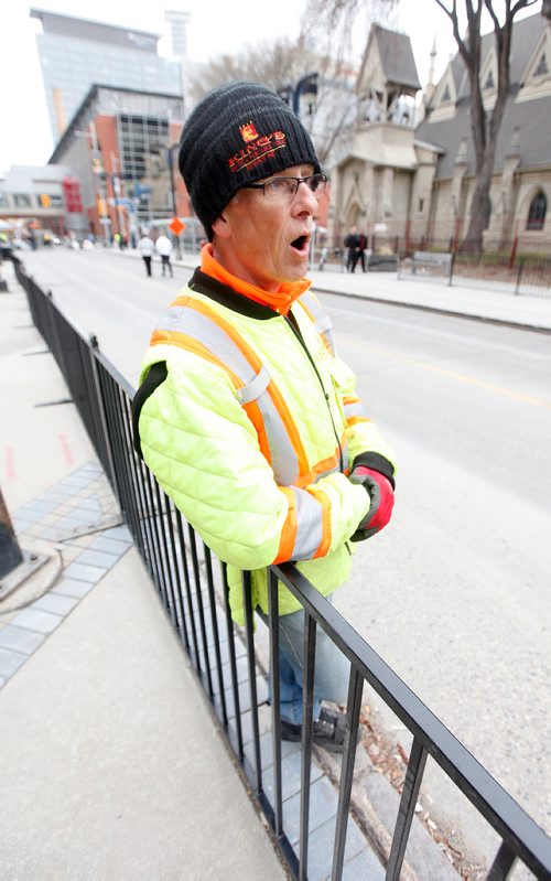 PHIL HOSSACK / WINNIPEG FREE PRESS - STREET PARTY - Terry Rempel leans on some of the fence he's installed on downtown streets for the Jets Whiteout Party Tuesday.   Jessica's story.  - May 1, 2018